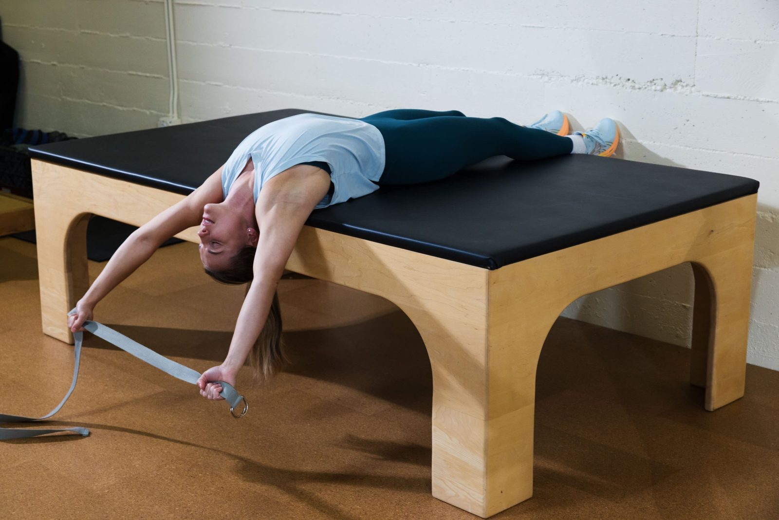 A woman in athletic attire stretching on a table at ActiveLab in Vancouver, Washington